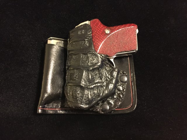 Red Kevlar grips in Alligator head Holster with attached Mag.
